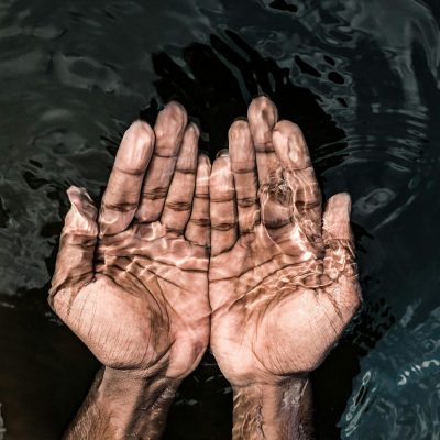 pexels-photo-4515858-4515858 From above of crop anonymous male washing hands in clean water of lake in daytime